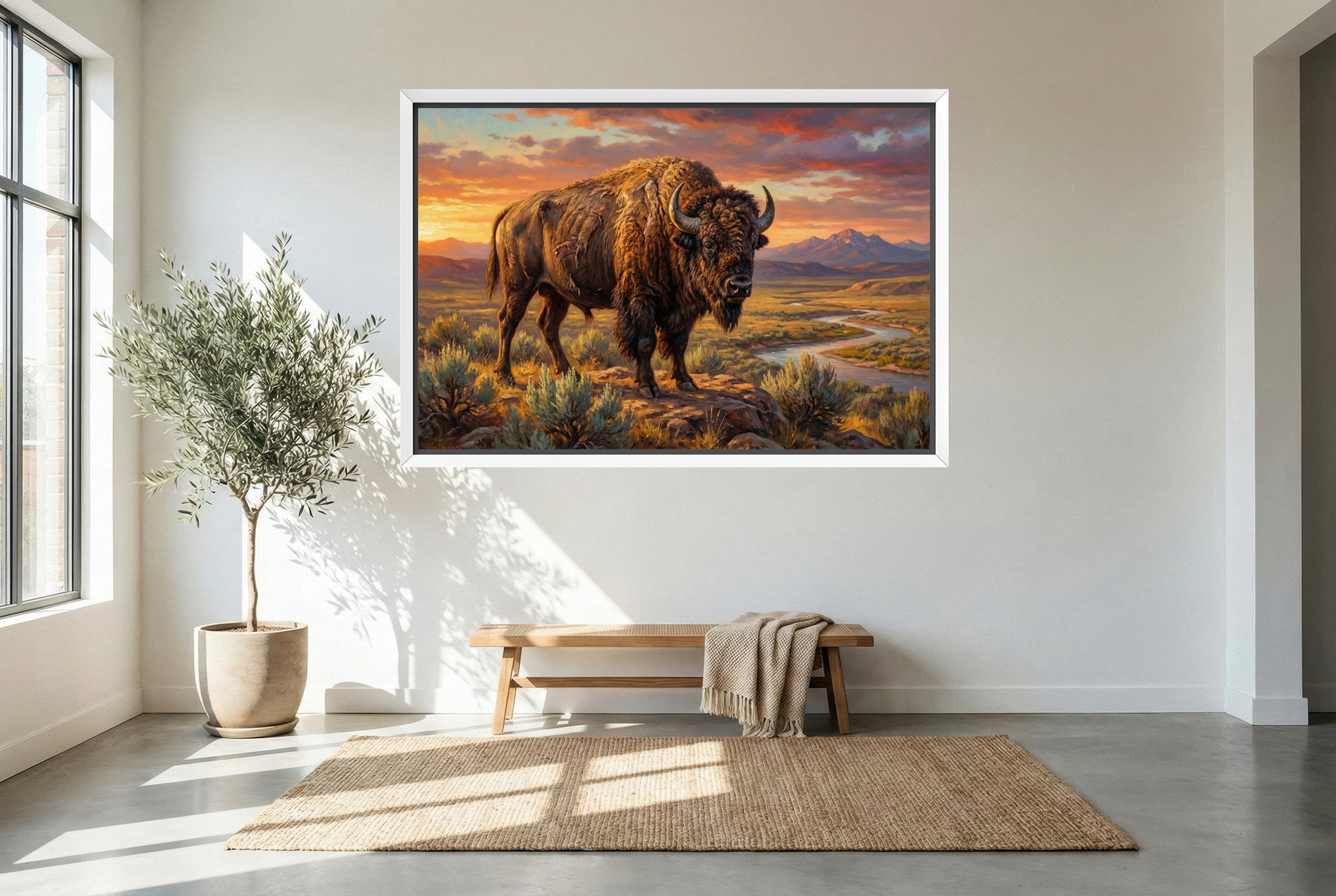 white floating framed canvas art of a Bison standing on a rocky outcrop with a scenic landscape and sunset in the background
